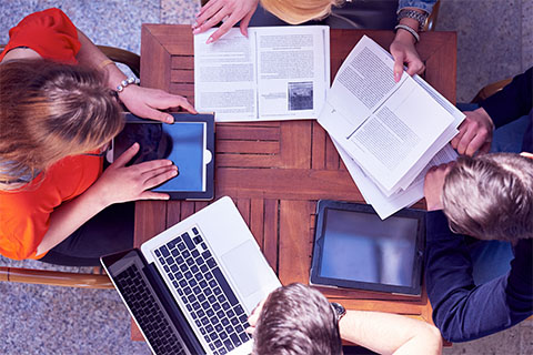 People working around a table with papers